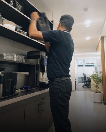 Workplace manager restocking a coffee pantry